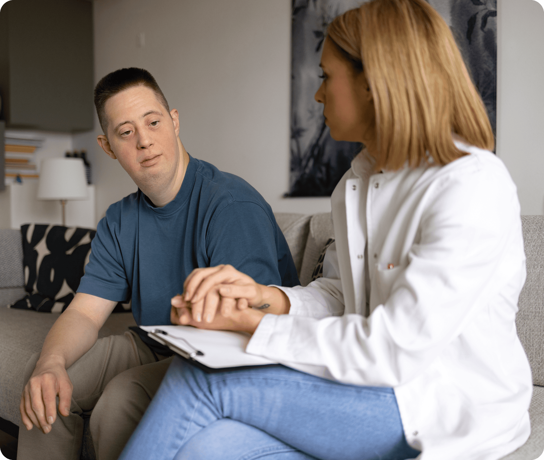 Woman holding man's hand during counseling session